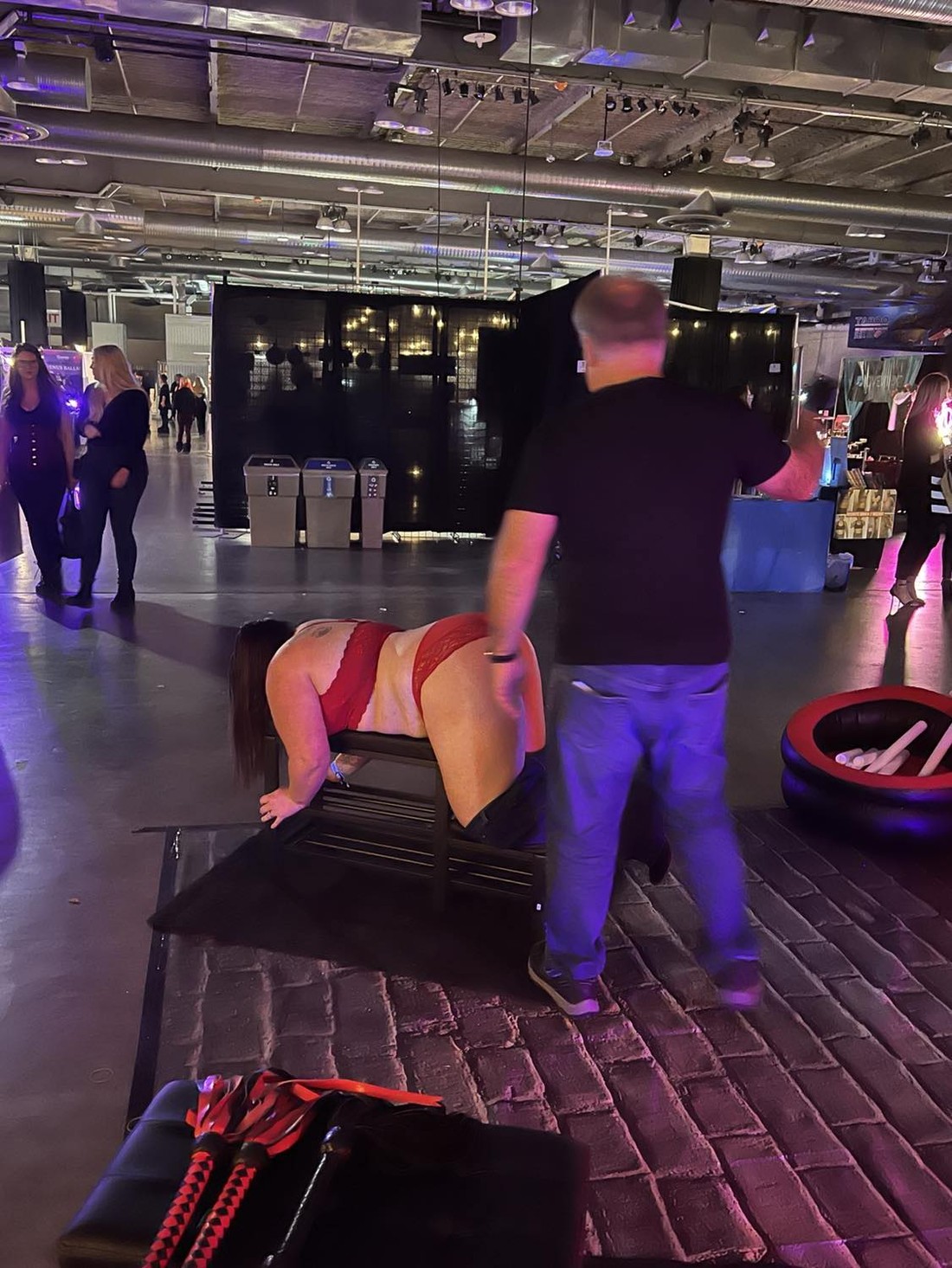 Spank Daddy conducting a live sensual flogging demonstration at an adult lifestyle event Spank Daddy conducting a live sensual flogging demonstration at an adult lifestyle event