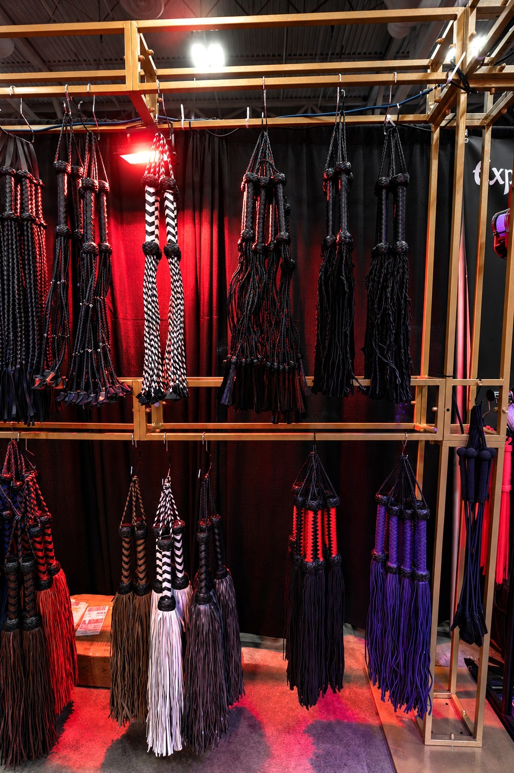 Black, red, white and purple floggers displayed at a Spank Daddy adult lifestyle event Black, red, white and purple floggers displayed at a Spank Daddy adult lifestyle event