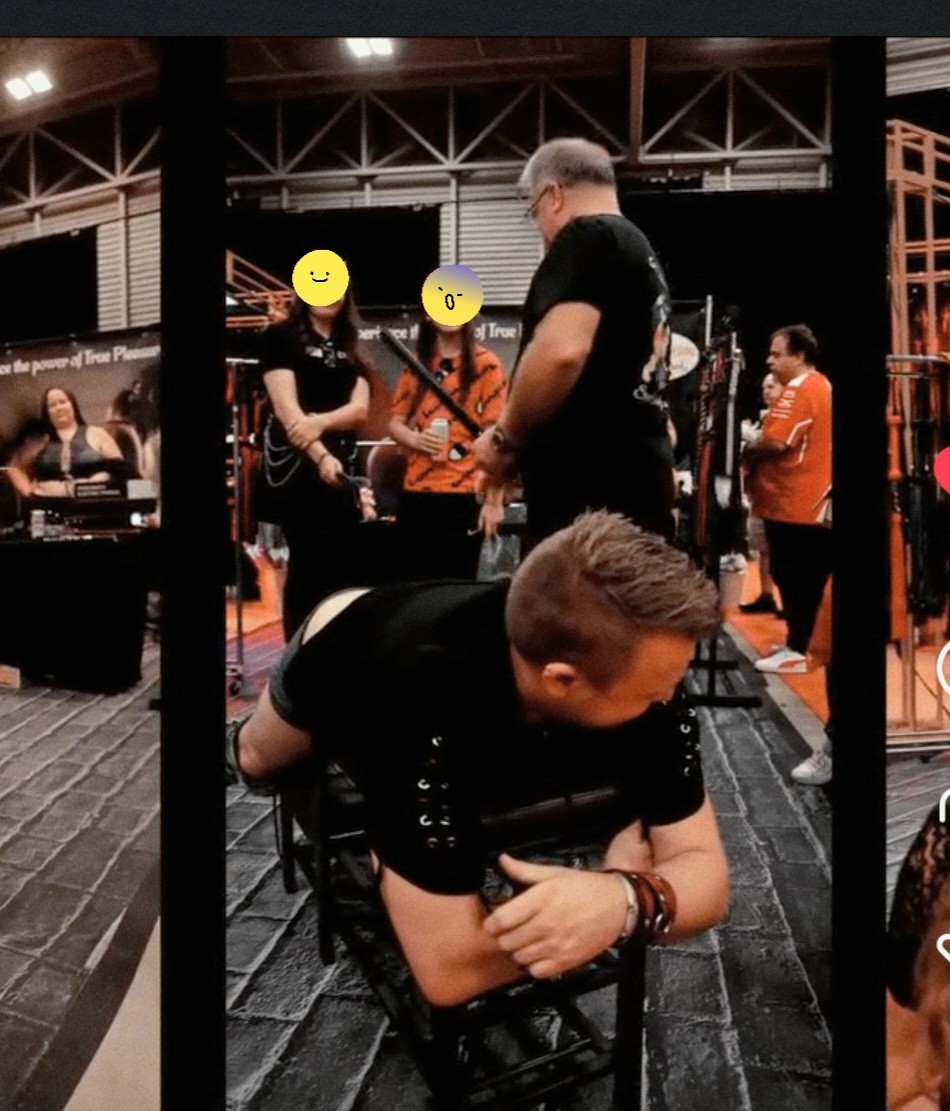 Spank Daddy teaching sensual flogging with adult participants during a live trade-show demonstration